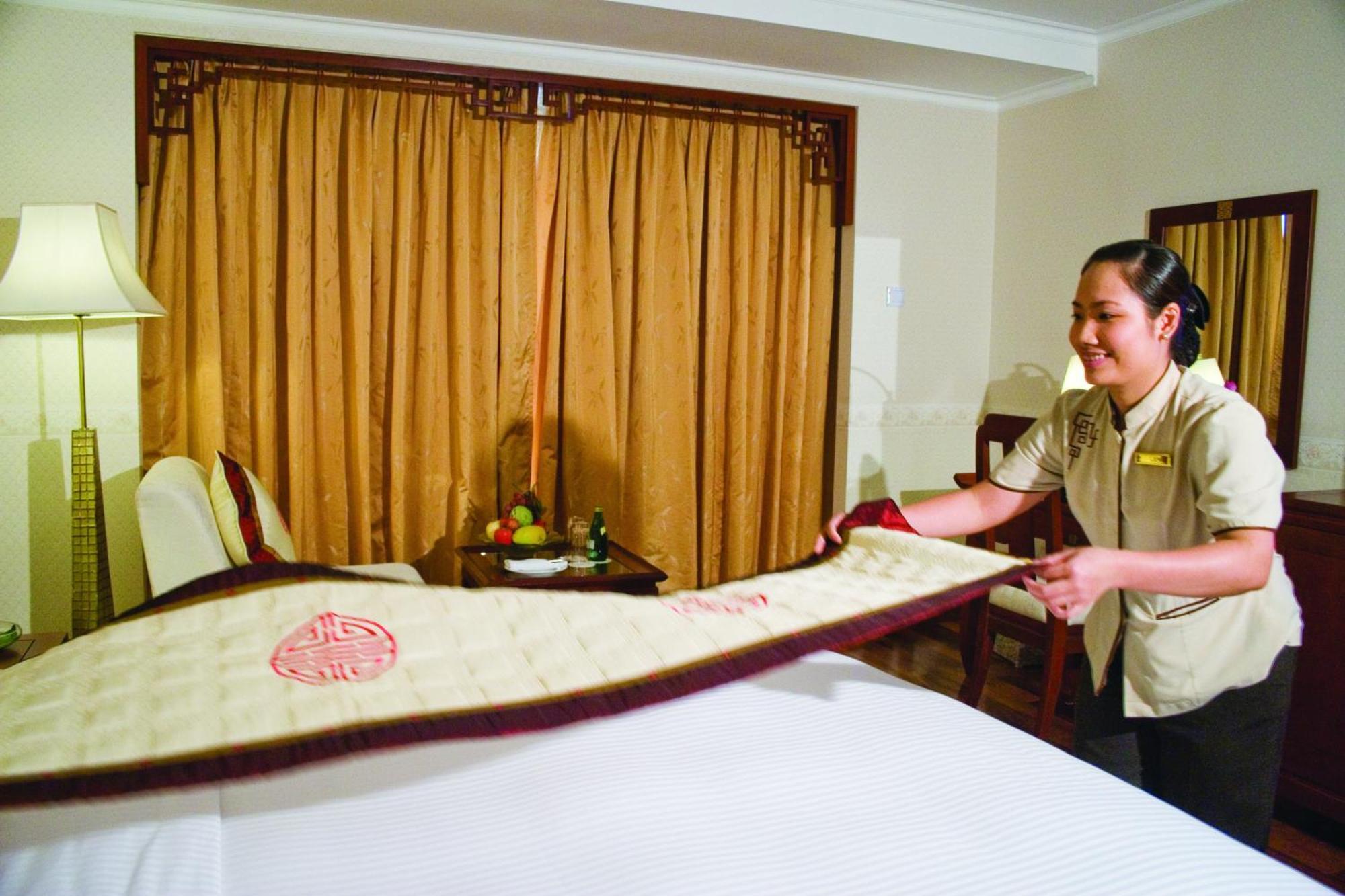 Rex Hotel Ho Chi Minh City Exterior photo A hotel housekeeper making a bed
